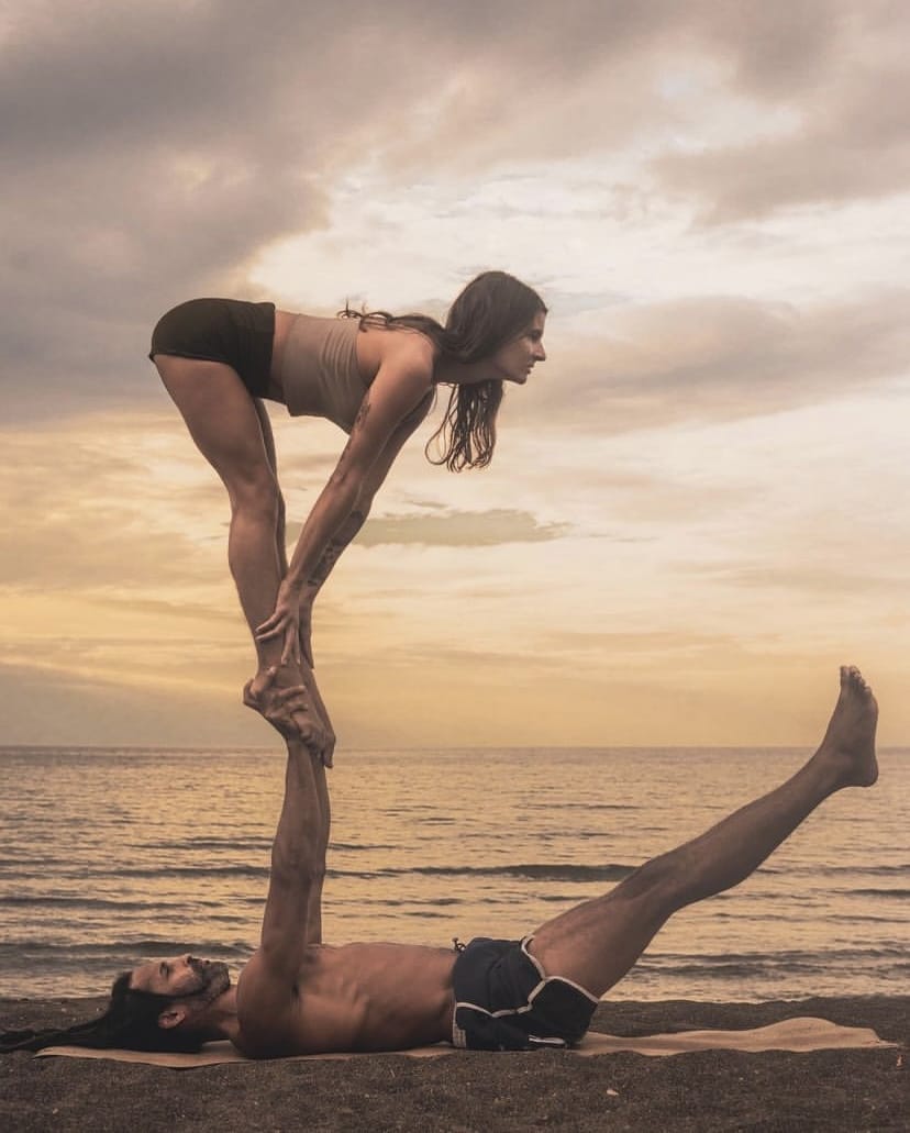Couple practicing acro yoga outdoors. Acroyoga concept. Front Bird pose.  Asana for beginers Stock Photo | Adobe Stock